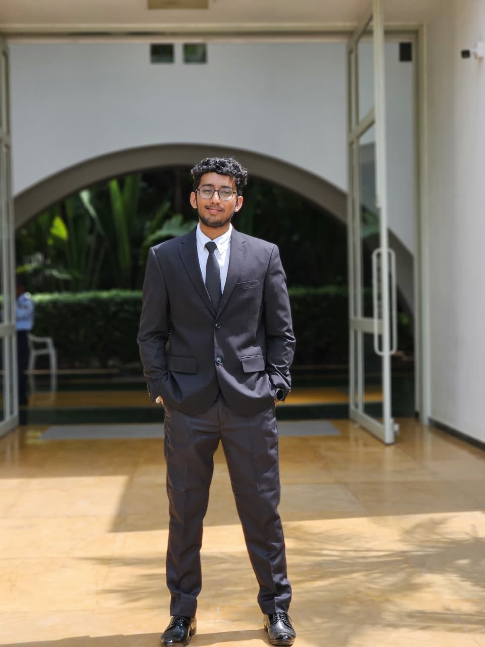Prem Joshi, founder of Neev India, standing in front of an arched doorway